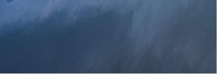 A close-up of a dark, textured surface, possibly metal or painted material.