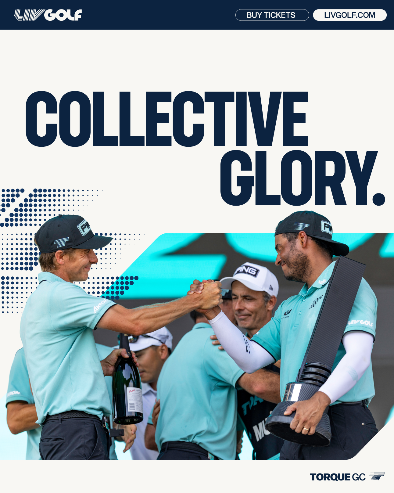 Two golf players shaking hands on a golf course, with one holding a large trophy and a bottle of champagne, wearing matching light blue shirts and caps, celebrating victory.