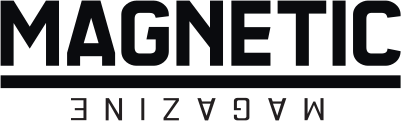 Close-up of a sign with partially visible text reading 'MAGNETIC' in black letters on a dark background.