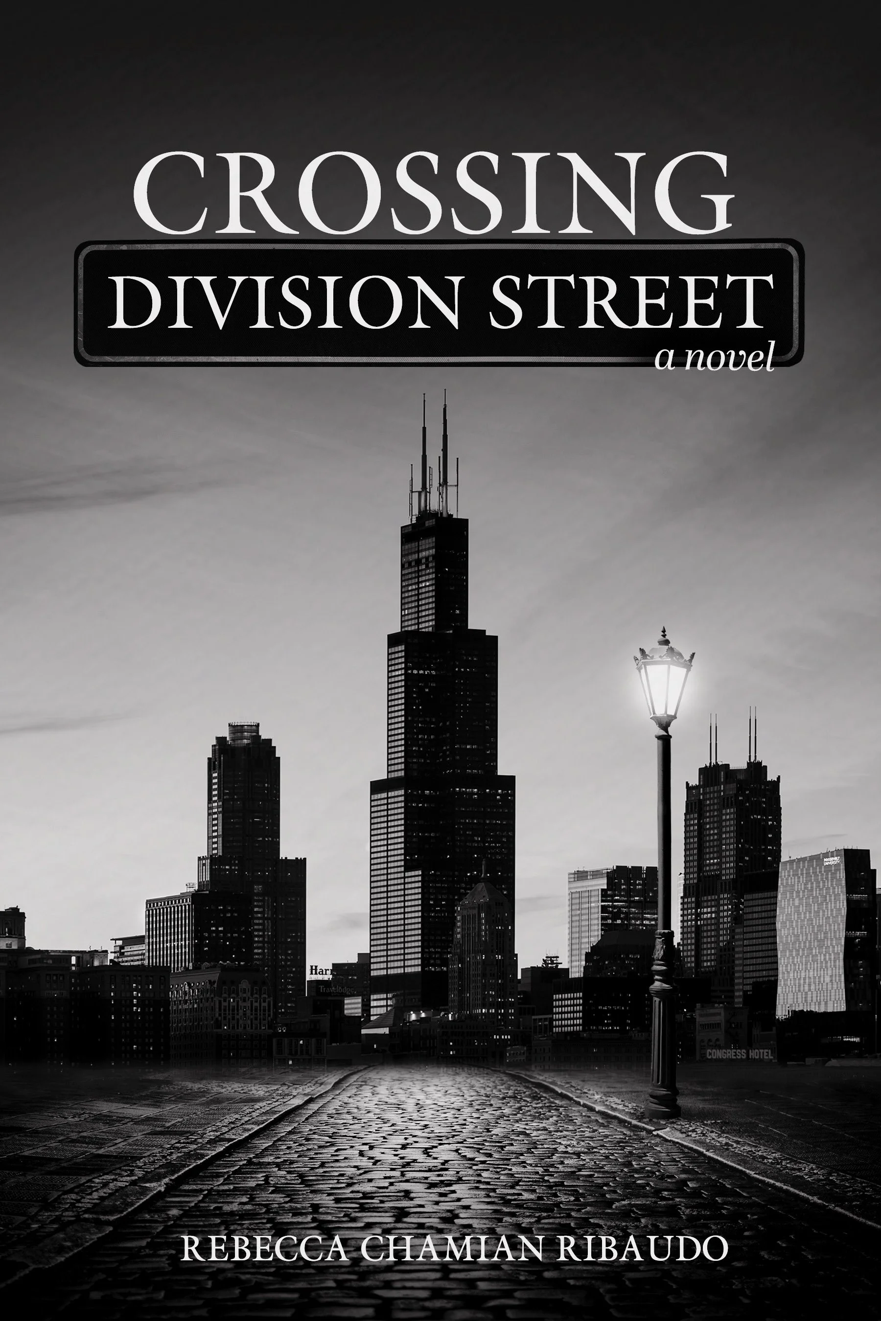 Black and white image of a city skyline with tall buildings, a cobblestone street, and a lamppost. The text on the image reads "Crossing Division Street: a novel" and the author's name, Rebecca Chaman Ribaudo.