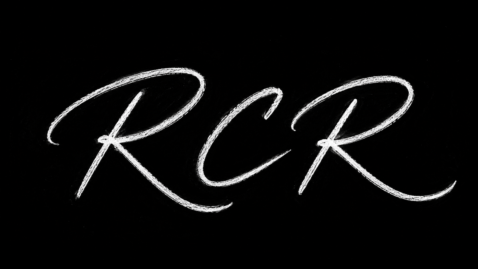 Neon sign displaying the word 'RCR' in white cursive letters on a black background.