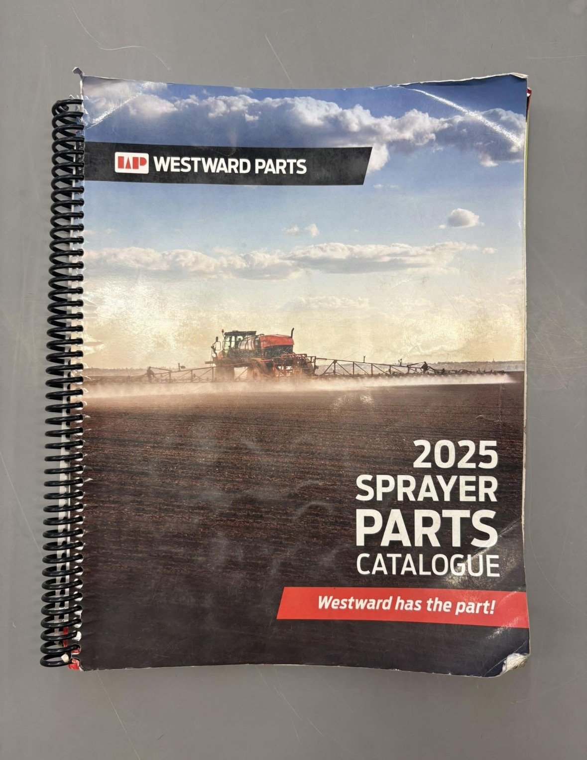 Cover of a 2025 sprinkler parts catalog by Westward Parts featuring a tractor spraying a field with a blue sky and clouds in the background.