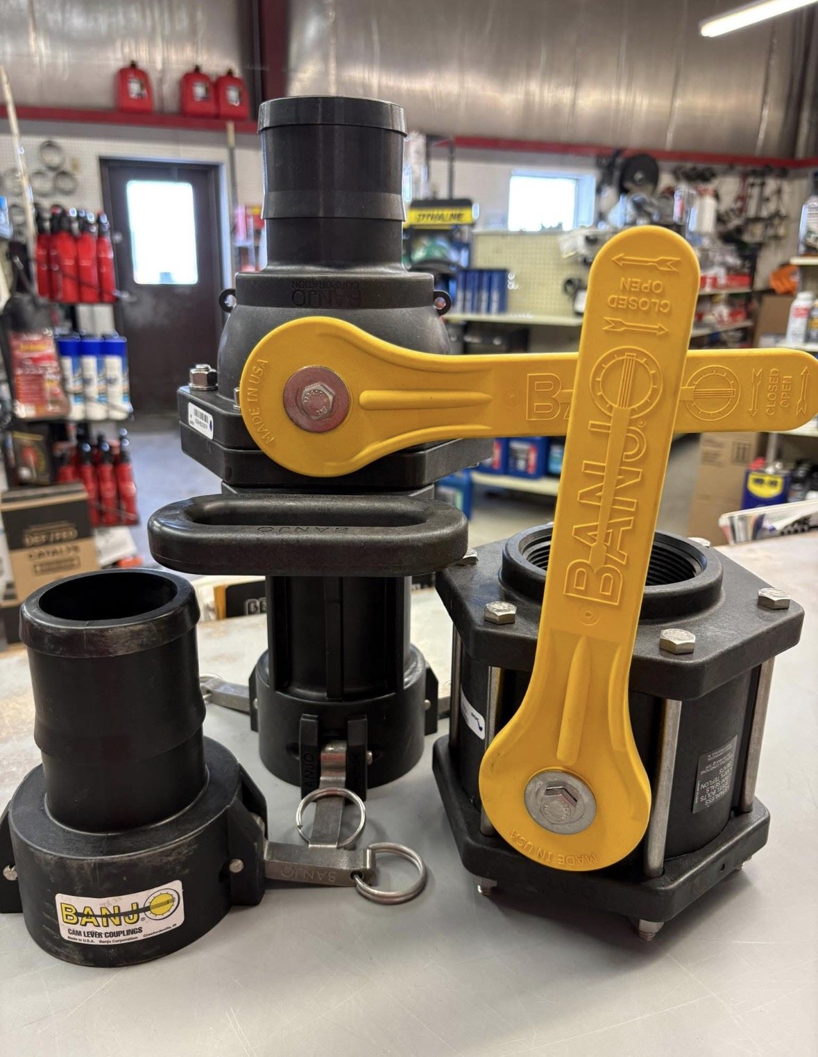 Various pipe coupling tools and fittings on a workbench in a hardware store.