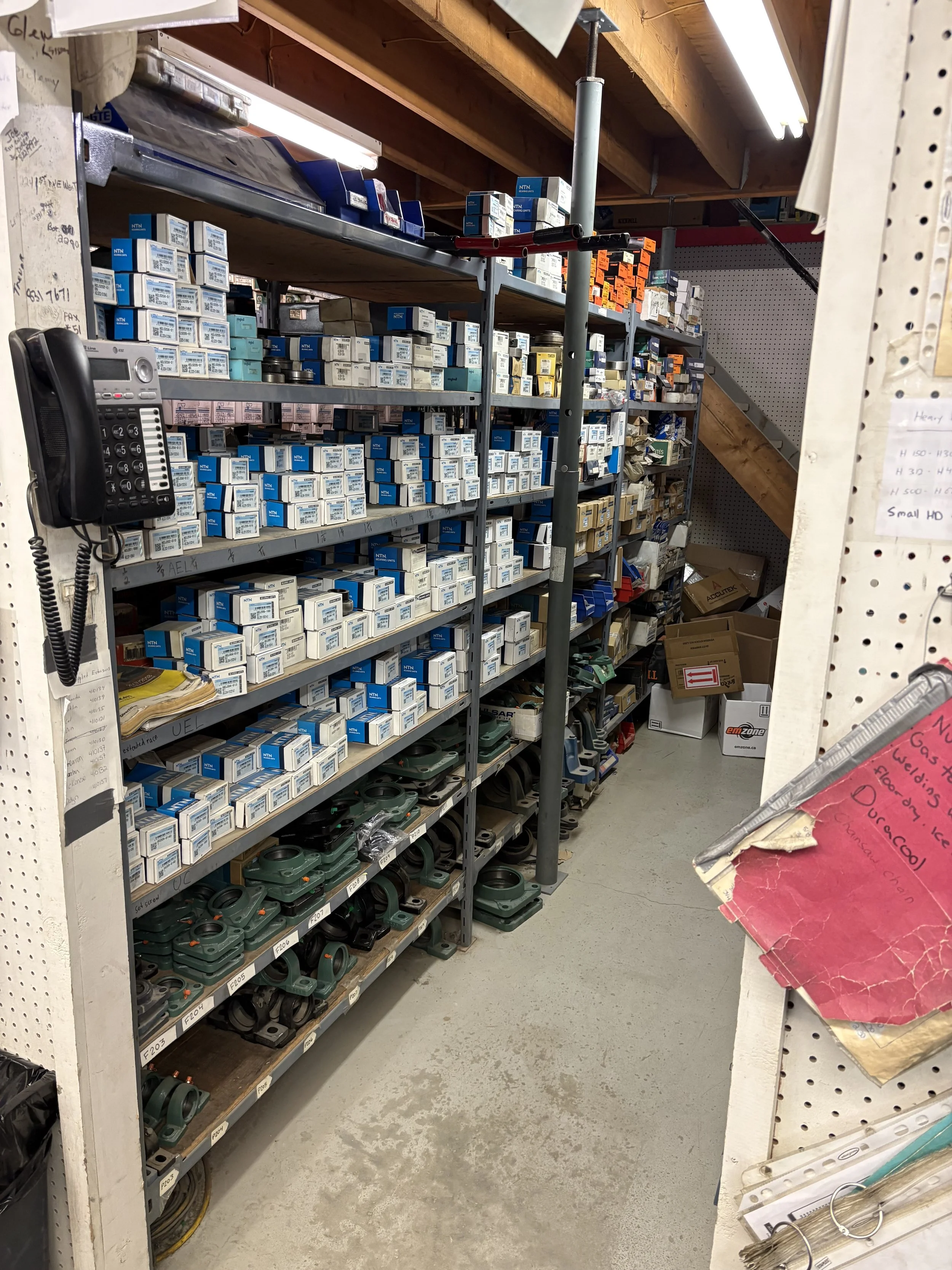 Shelves filled with various parts and boxes in an industrial supply storage room