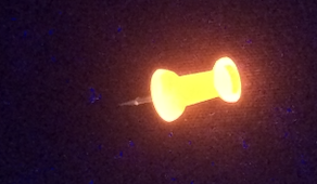 Neon thumbtack under UV light