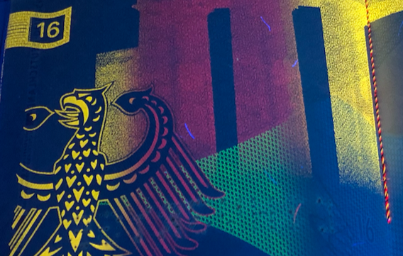 A close-up of a colorful, patterned surface with a stylized bird emblem and the number 16.
