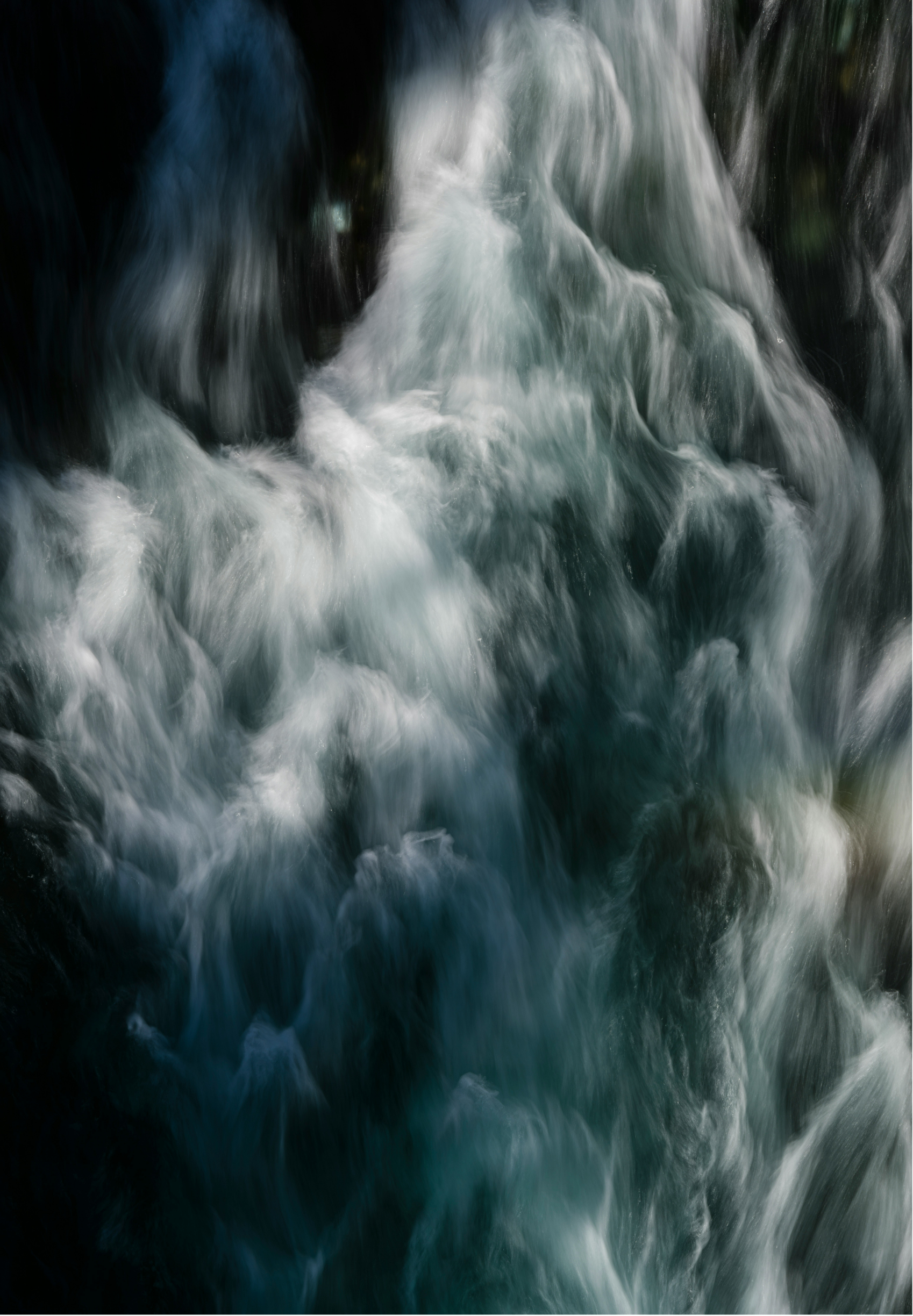 Flowing water in a river or stream with a long exposure effect, creating a smooth and blurred appearance of the water.