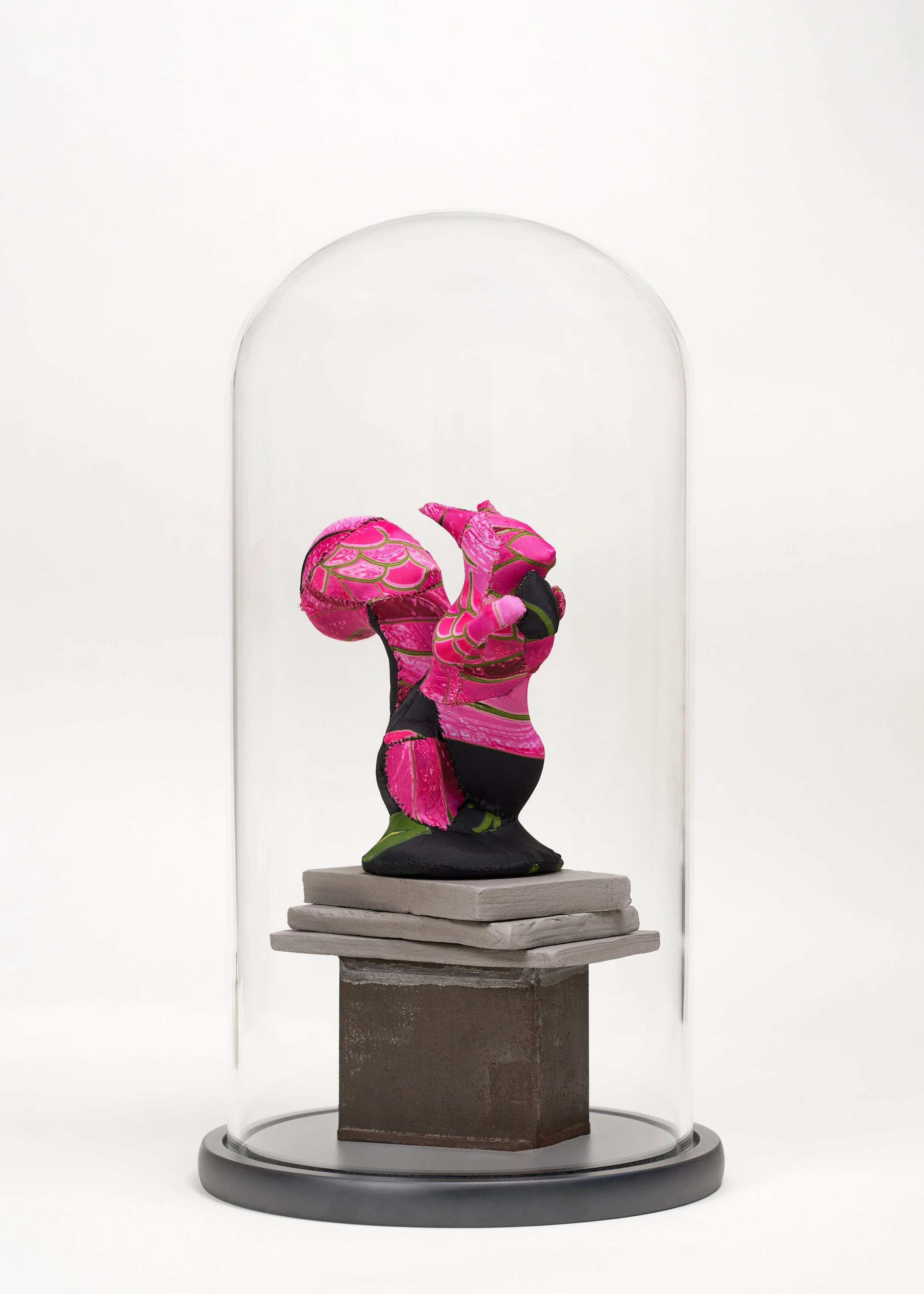 Squirrel / 
Ceramic sewn with fabric and thread, glass case on a wooden base. 
Squirrel: 16 x 16 x 9 / Case: 41 x 22 cm. 
2025