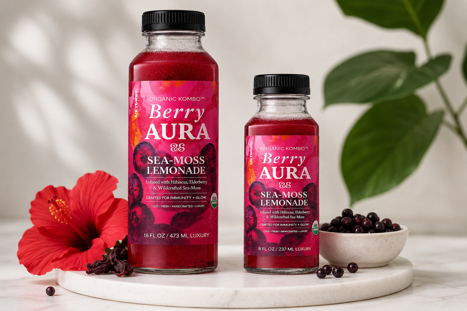 Organic Kombo Berry Aura Sea-Moss Lemonade in 8 oz and 16 oz bottles  with hibiscus flower, elderberries, and wildcrafted sea moss.