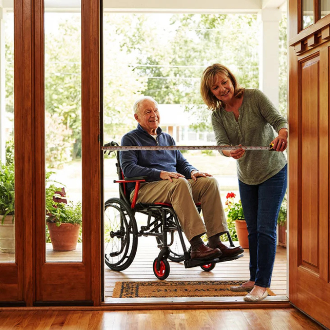 Woman measuring doorway width for wheelchair clearance during a home accessibility assessment representing Melesh Construction Dallas mobility renovation consultation process