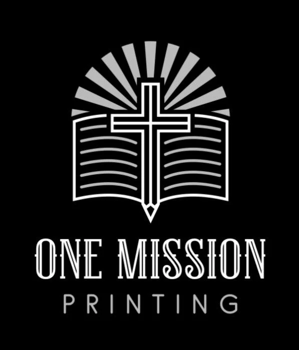 Logo of One Mission Printing with a cross, book, and rays of light on a black background