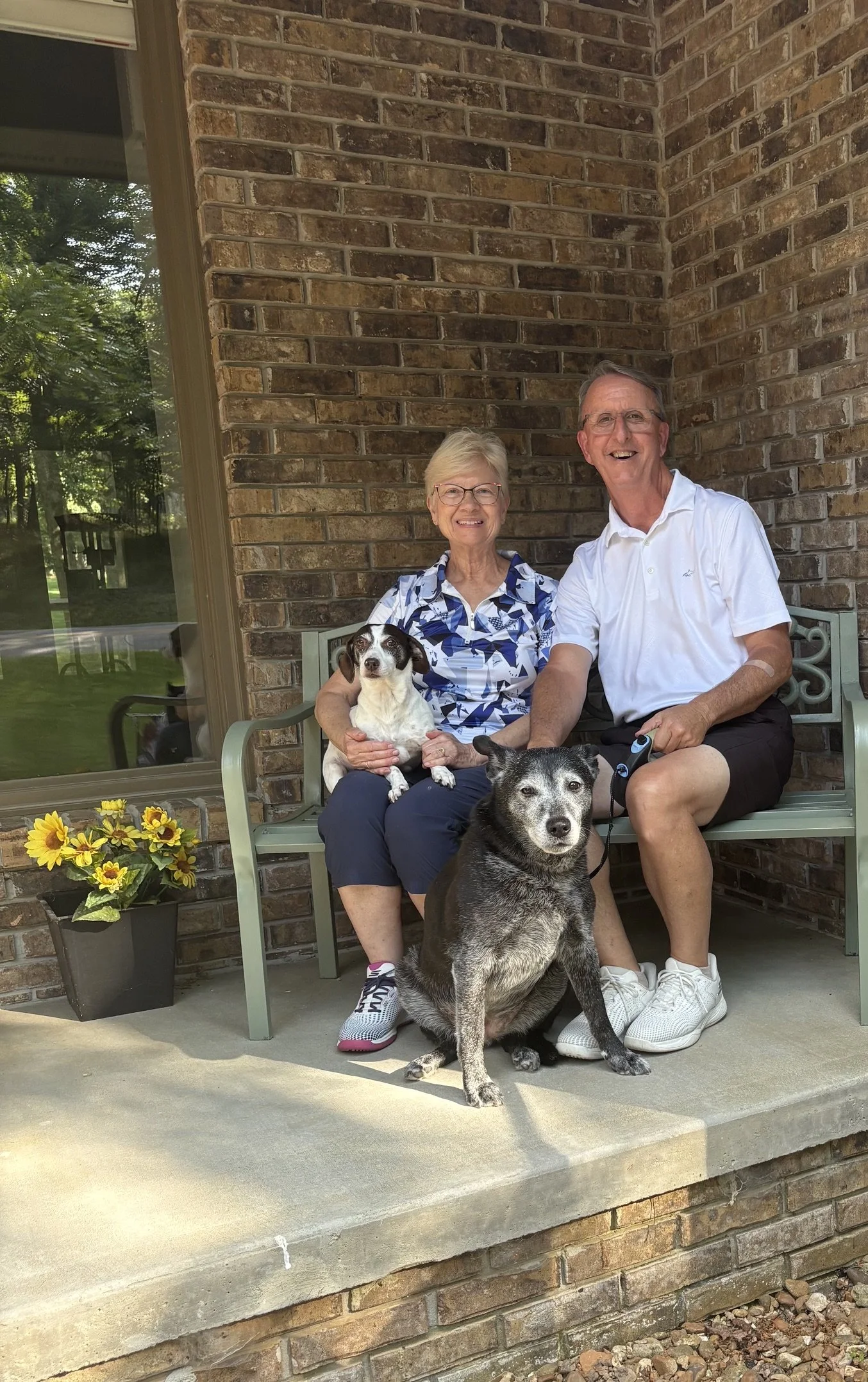 The Whirl family and their dogs are sitting on the porch of their home in Fairfield Glade, Tennessee.