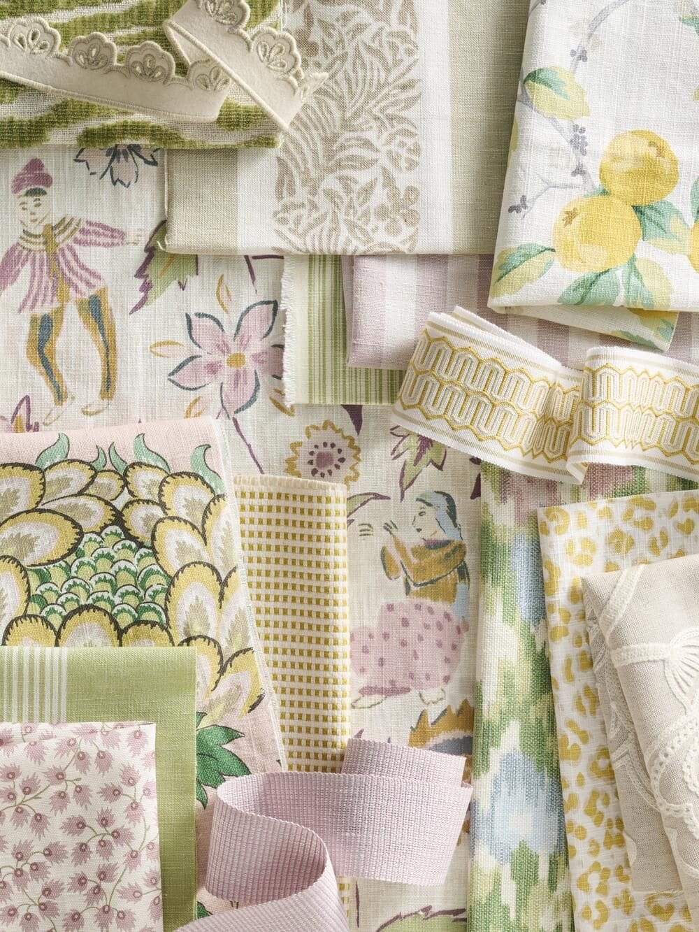 Various fabrics with floral, fruit, and decorative patterns in pastel colors layout.