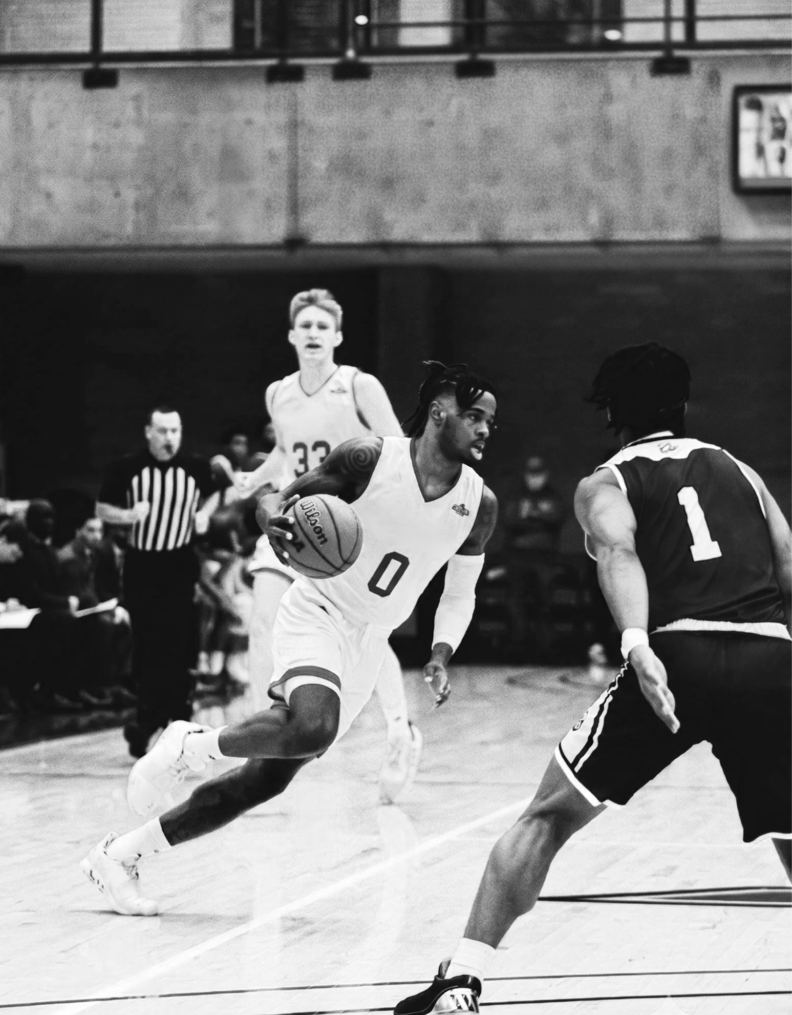 A representation of the athletic events and campus community at Telos (college founded by Charlie Anastasi) in Philadelphia, two basketball platers in action during a game. One college player is dribbling towards the basket.