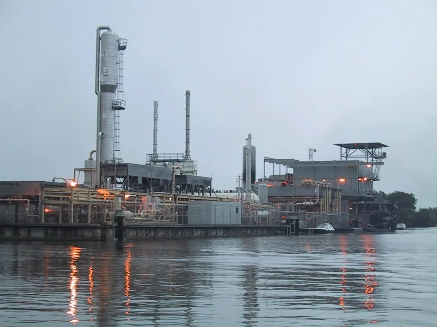 Off-shore oil facility with industrial pumping and automated controls.