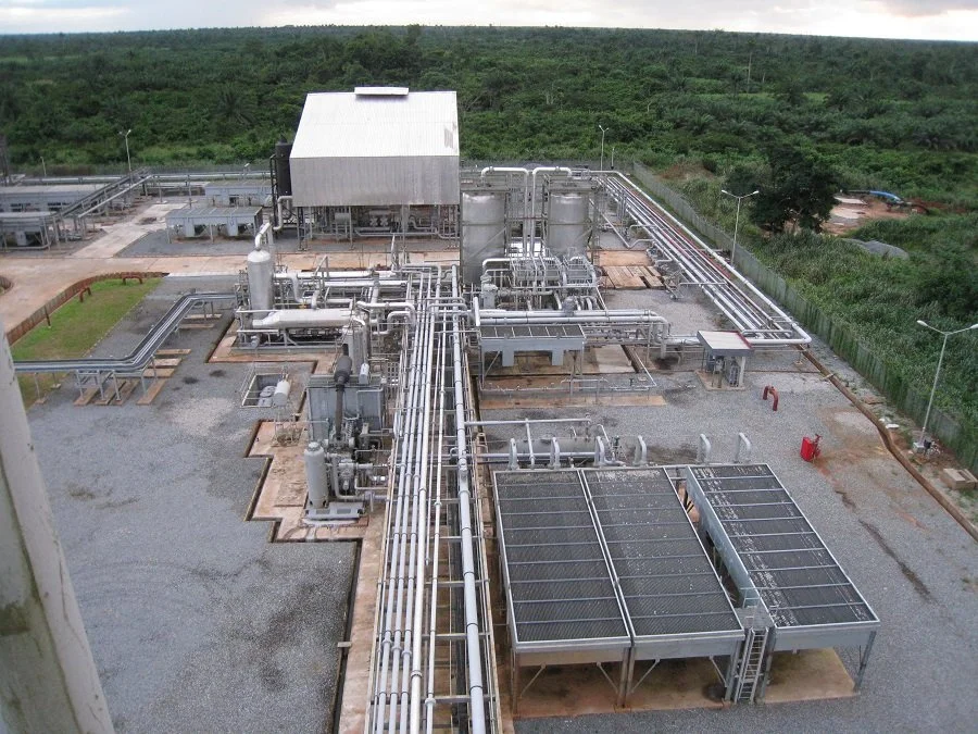 Industrial facility for oil production with pipes, tanks, and control equipment.