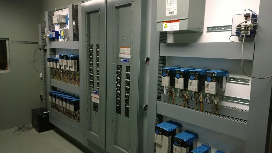 Clean and organized electrical control panel with switchgear and motor control.