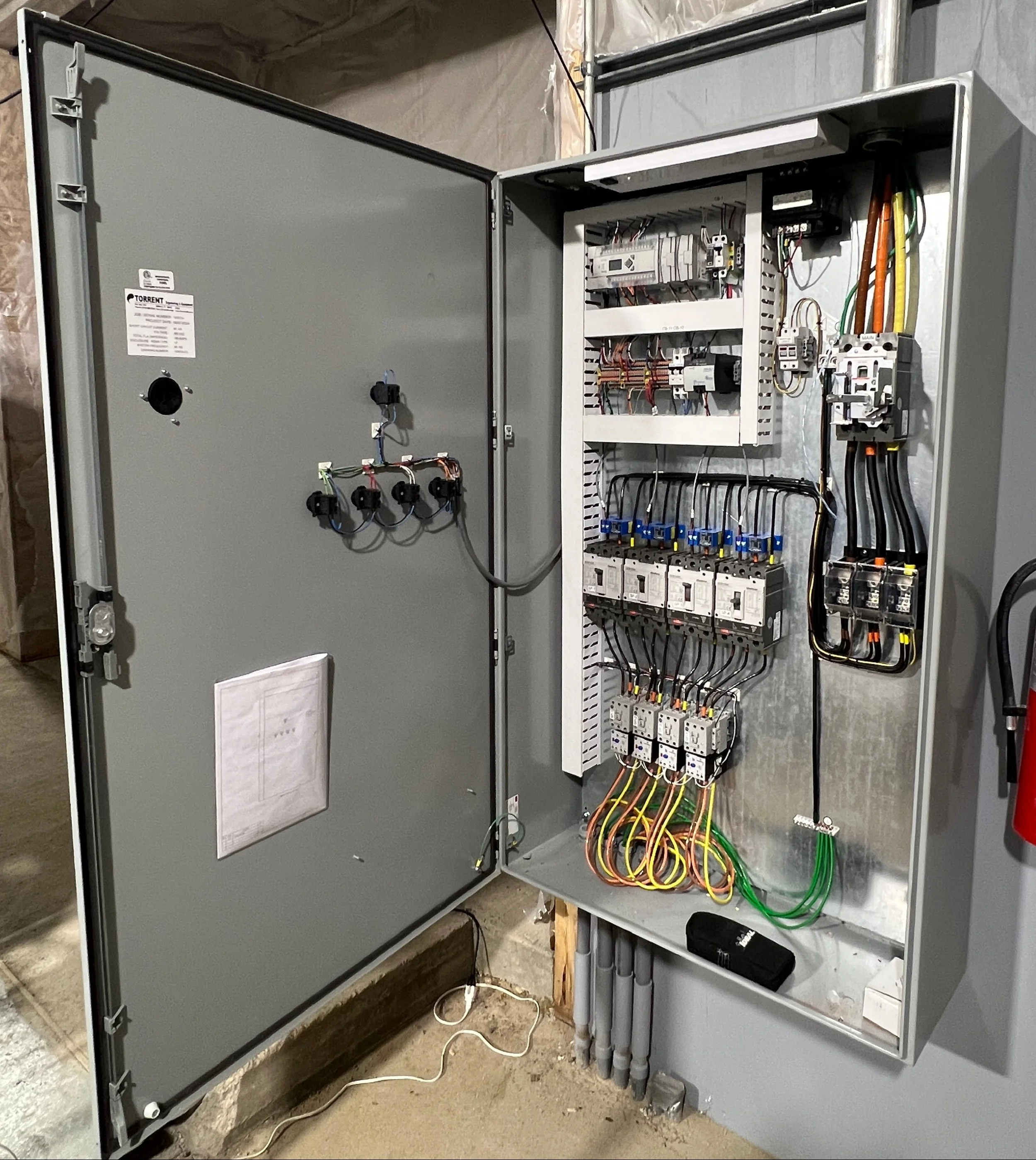 Clean and organized electrical motor control panel.