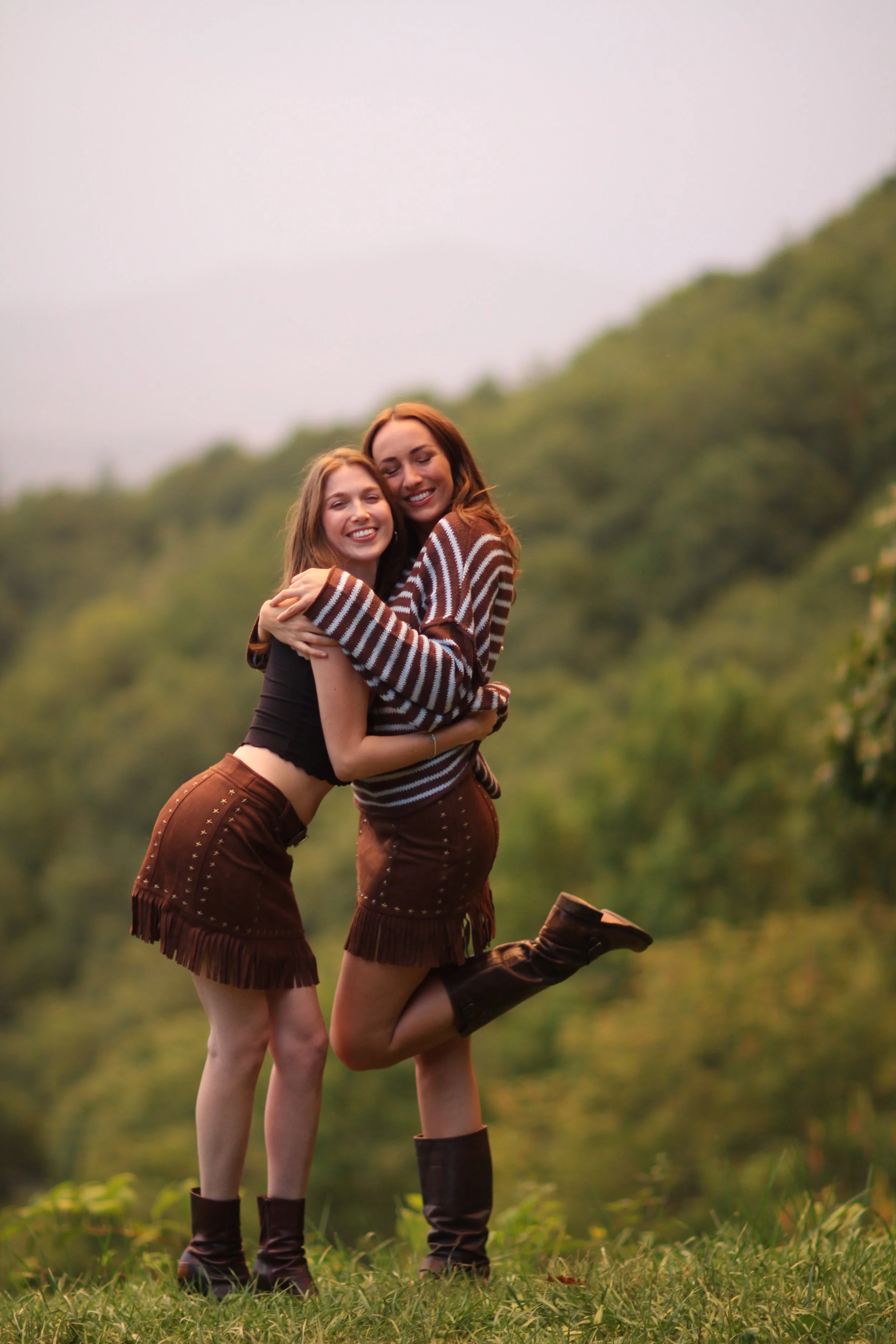 Two women wearing the Nashville Nights Fringe Skirt together, full body view