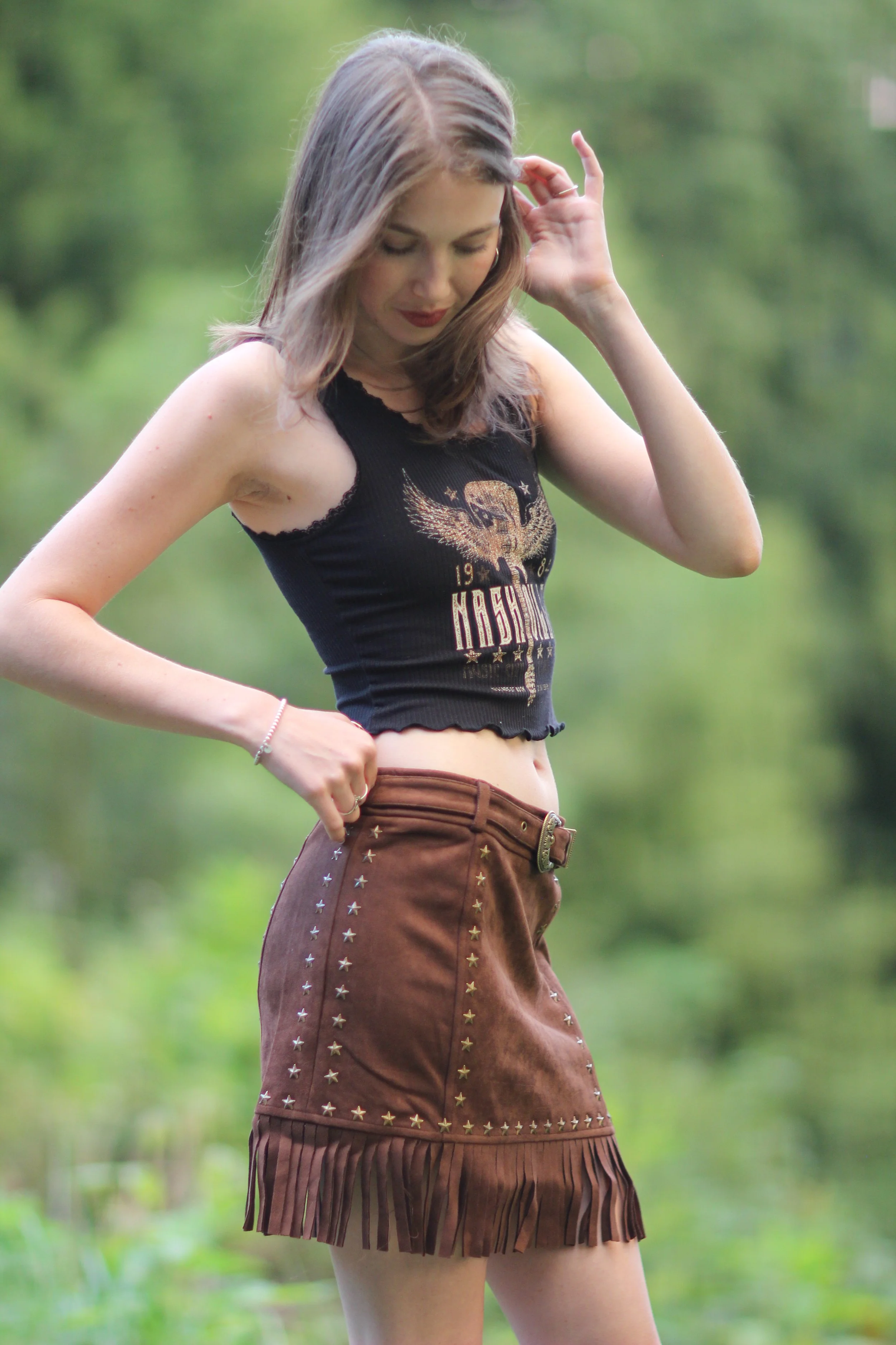 Woman posing outdoors in the Nashville Nights Fringe Skirt, candid pose