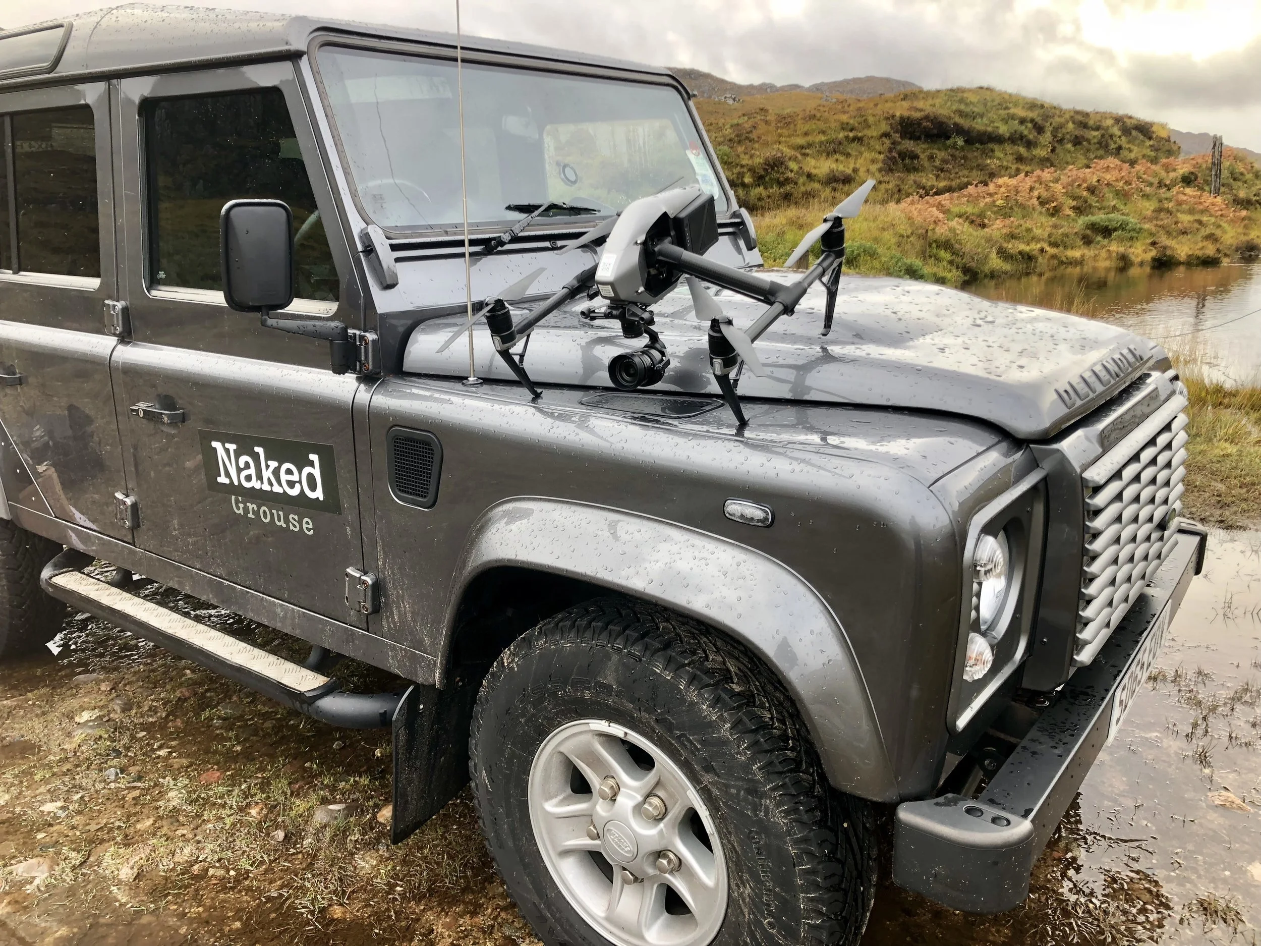 Land Rover Defender with drone mounted on the bonnet, liveried for The Naked Grouse whisky shoot on Scotland's north-west coast