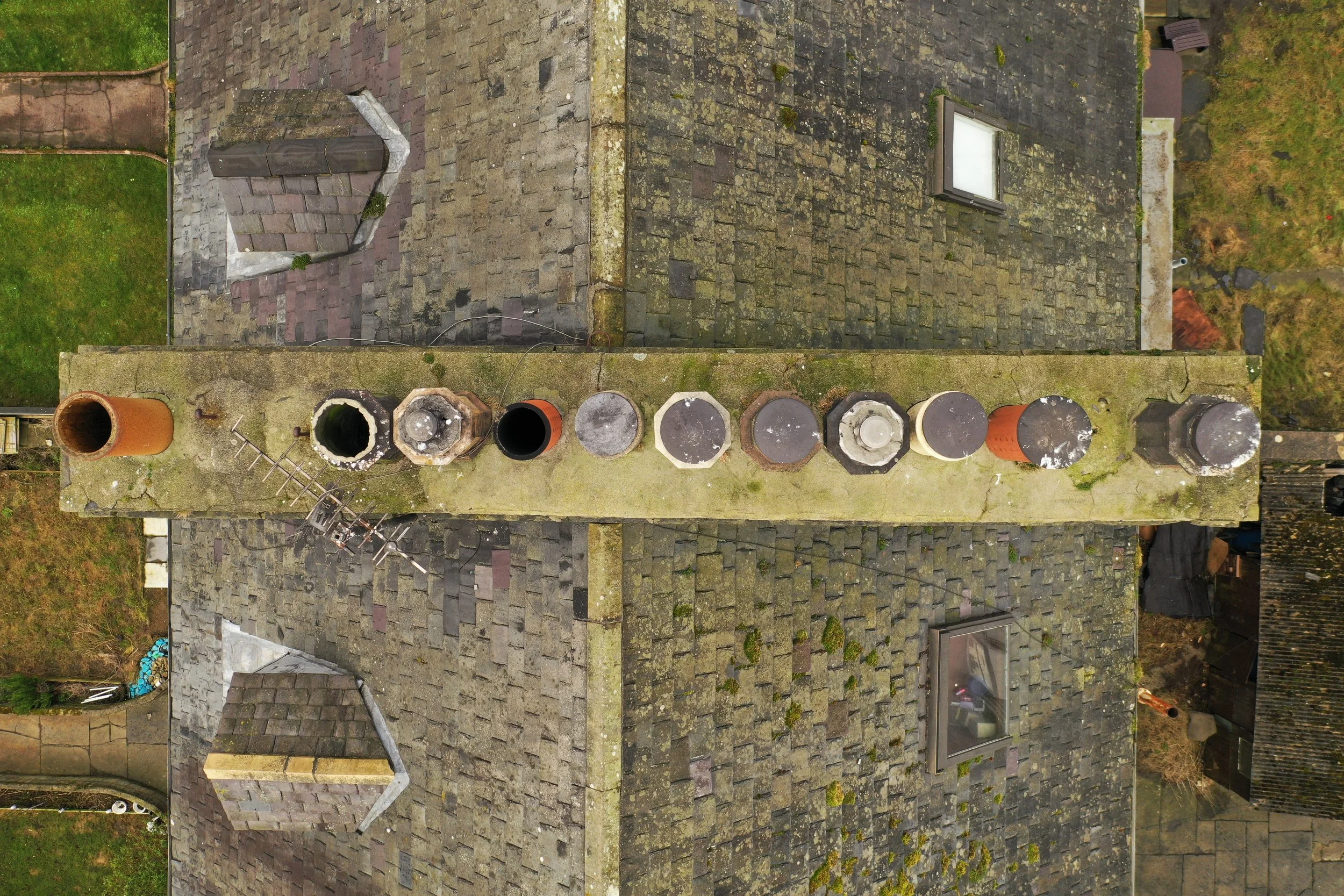 Aerial picture of a set of chimney pots in a state of bad repair