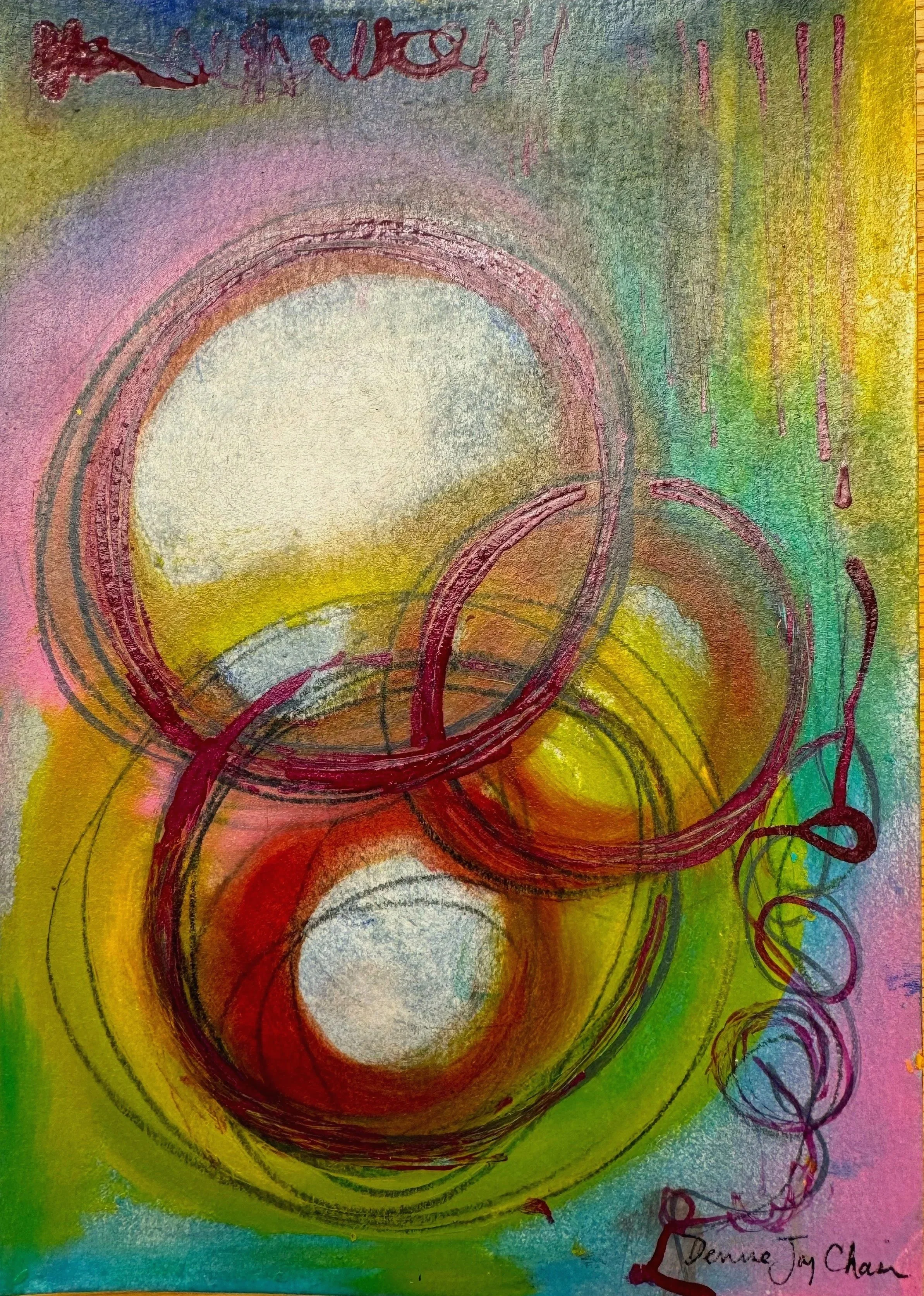 Colorful abstract artwork featuring spirals and overlapping circles in shades of red, yellow, green, purple, and pink. The background has a textured appearance with a mix of colors blending together. There is a signature in the bottom right corner that reads 'Denise Joy Chan'.