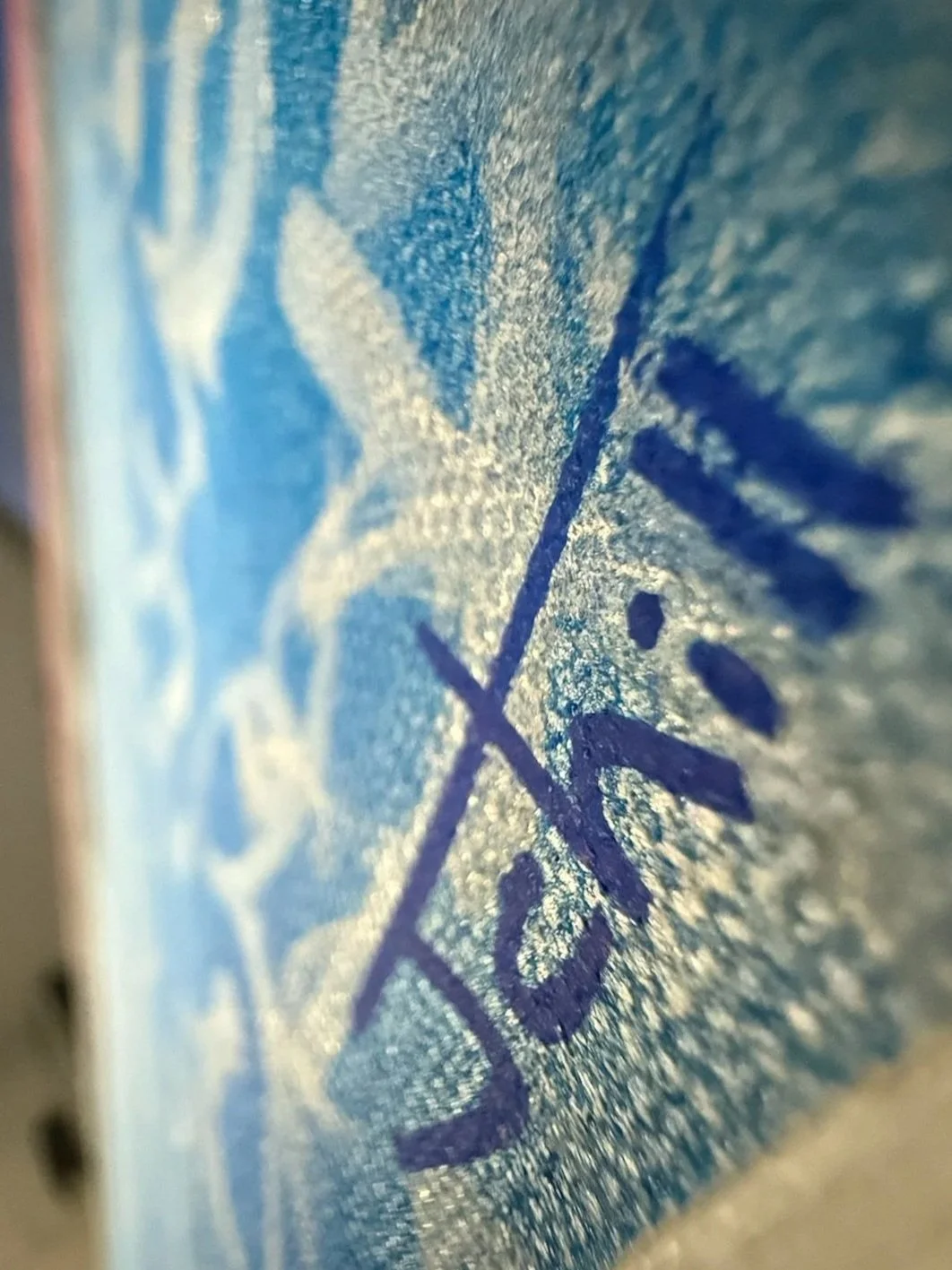 Close-up of a textured blue and white surface, possibly part of a printed or painted artwork.