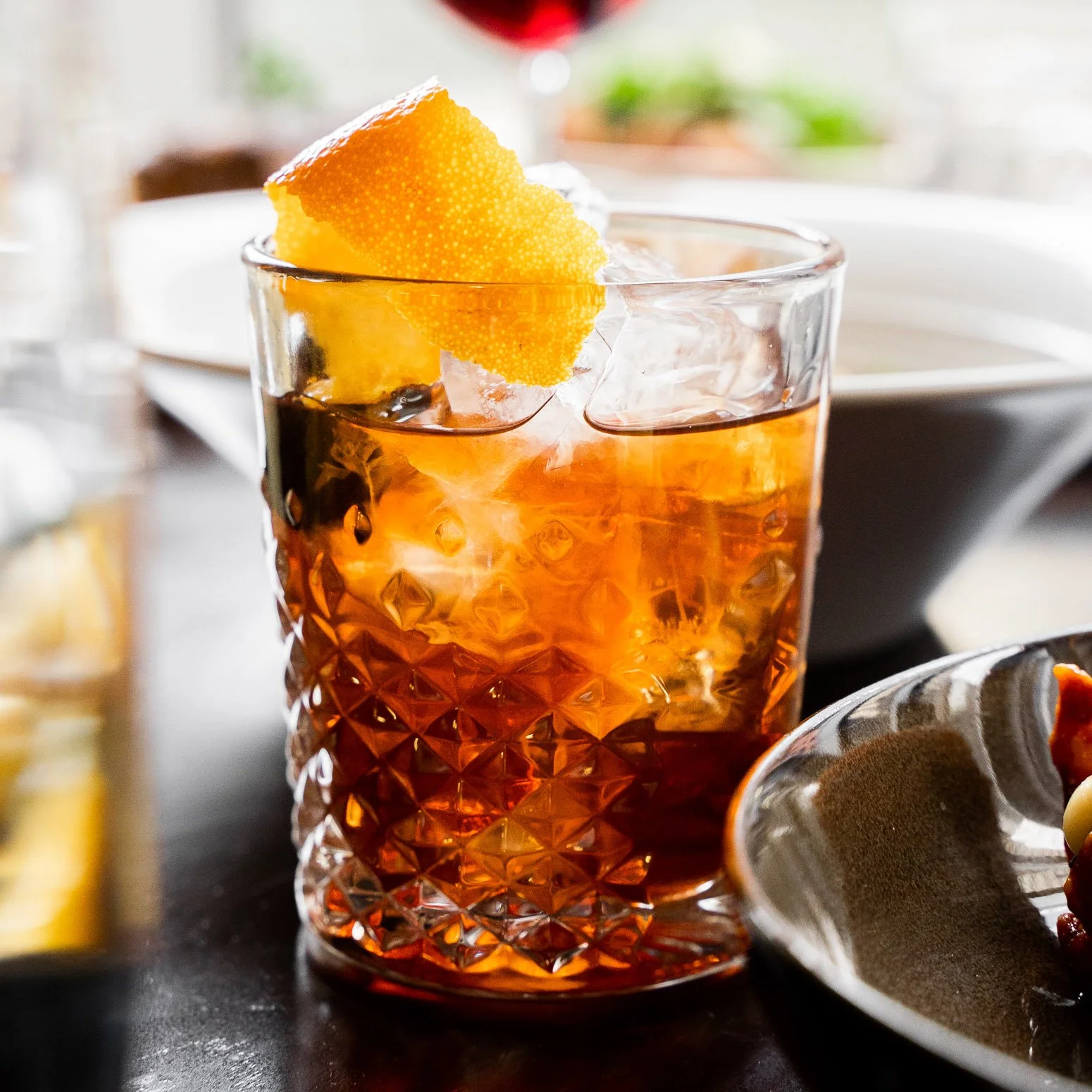 A glass of iced tea with a lemon wedge garnish on top.