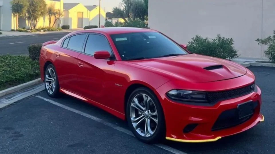Red sports sedan parked in a designated parking spot with a clear front view.
