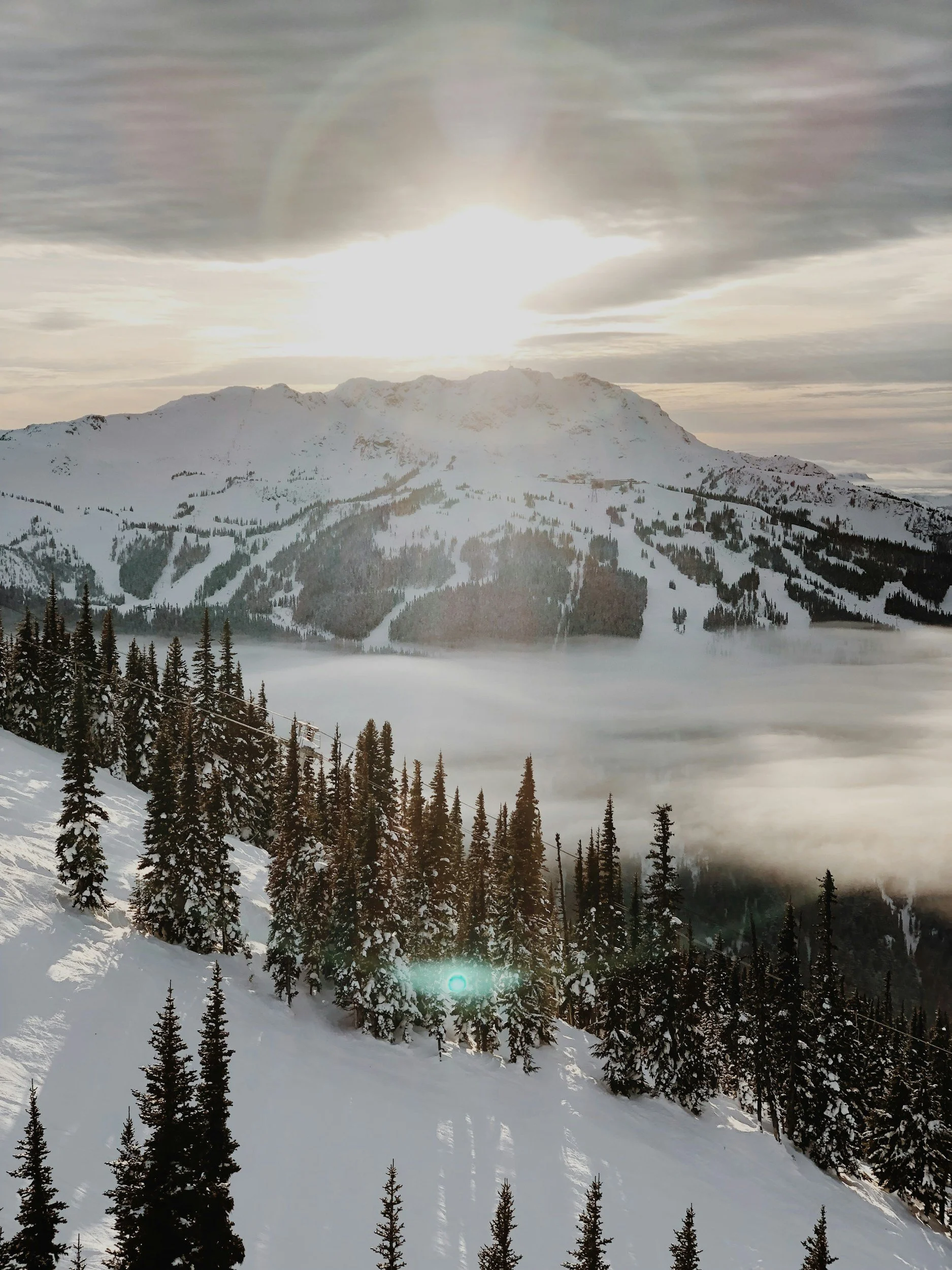 Snow-covered mountains in the Sea to Sky Corridor, highlighting the demanding climate architectural sheet metal systems are built to withstand.
