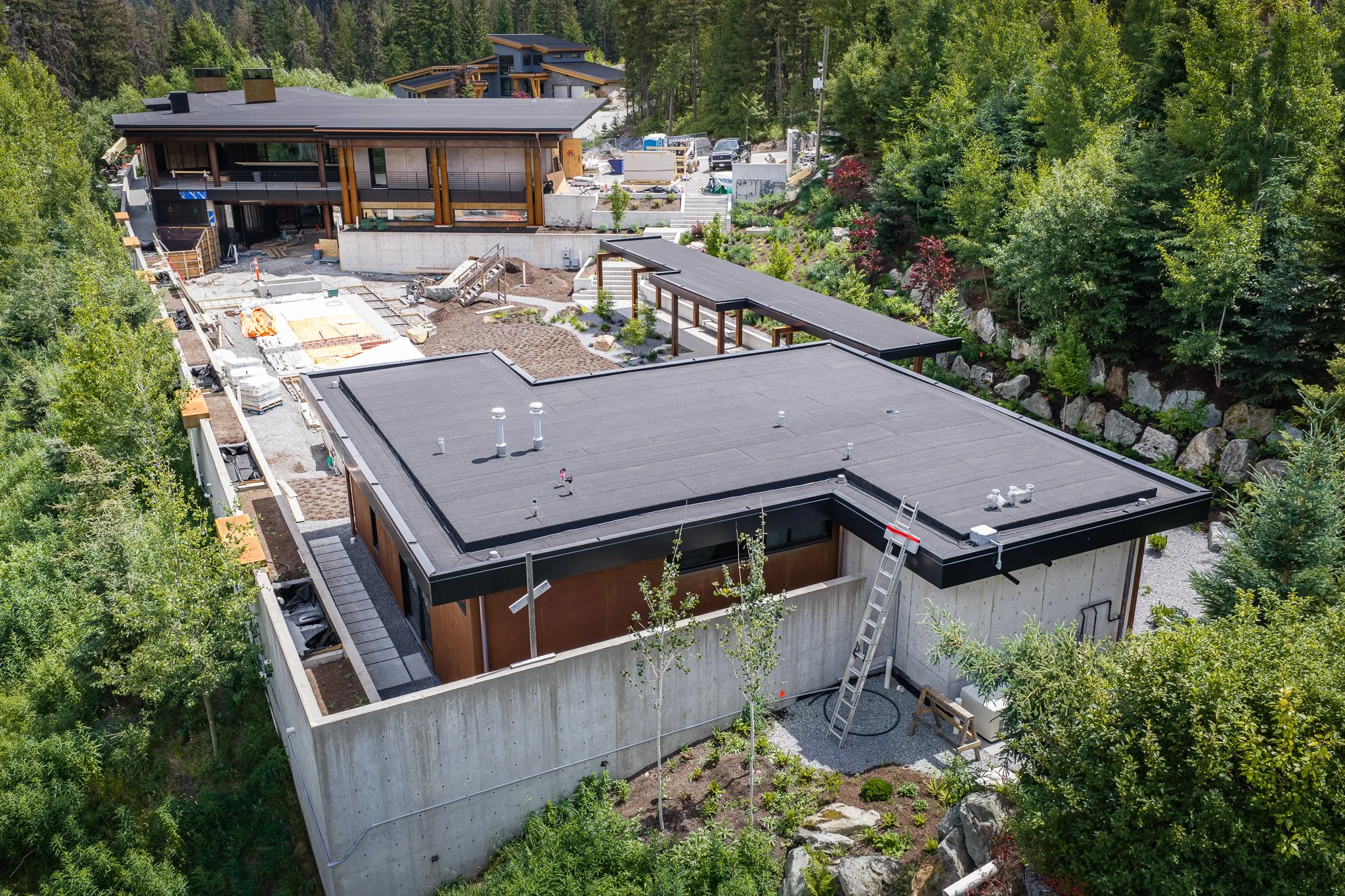 Modern custom home under construction featuring architectural sheet metal roofing designed for lasting performance.