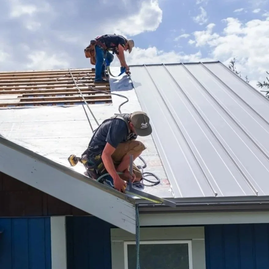 Wild Architectural Sheet Metal installing a standing seam metal roof with precision and attention to detail.