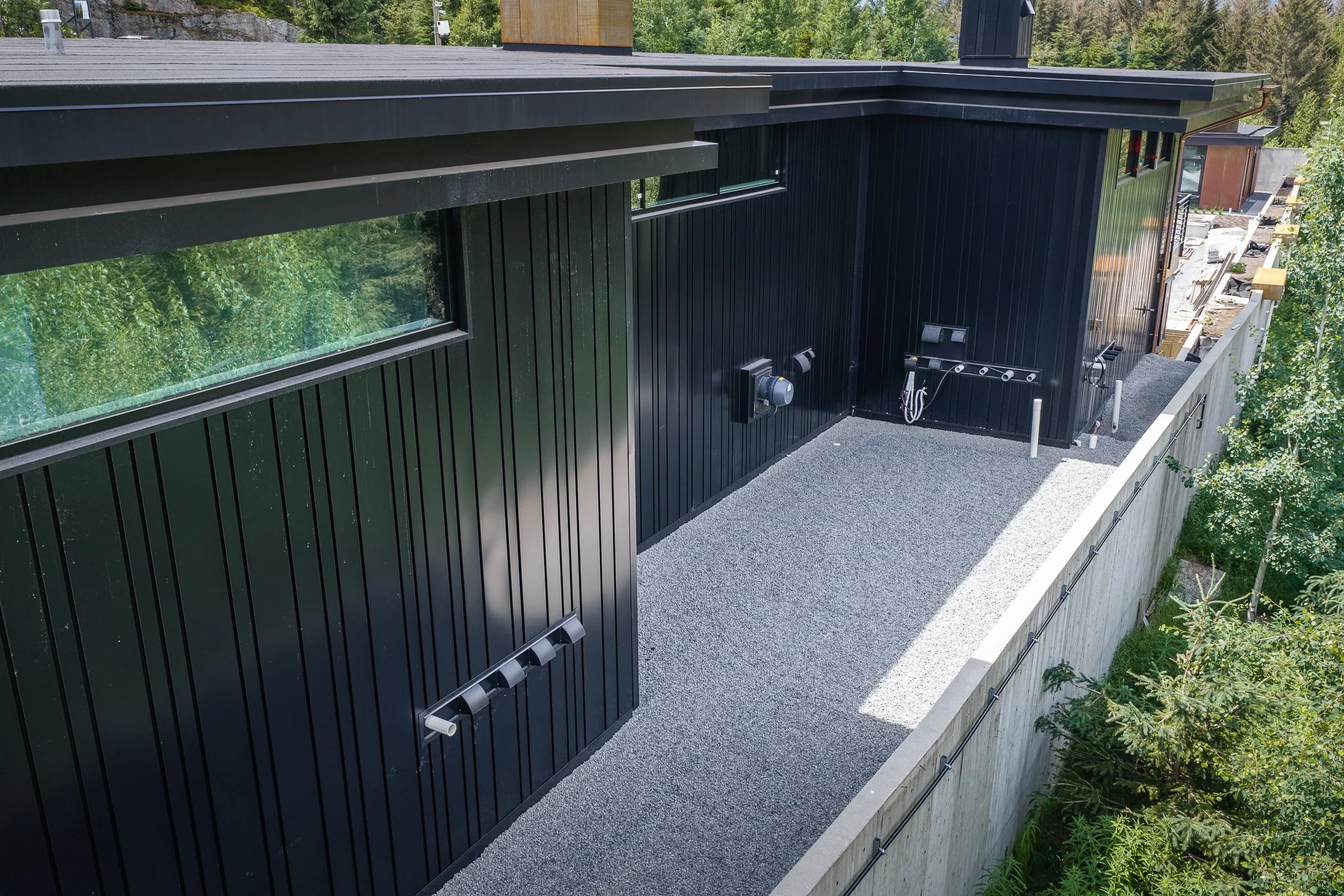 Architectural sheet metal wall cladding installed on a modern custom home, combining durability with contemporary design.