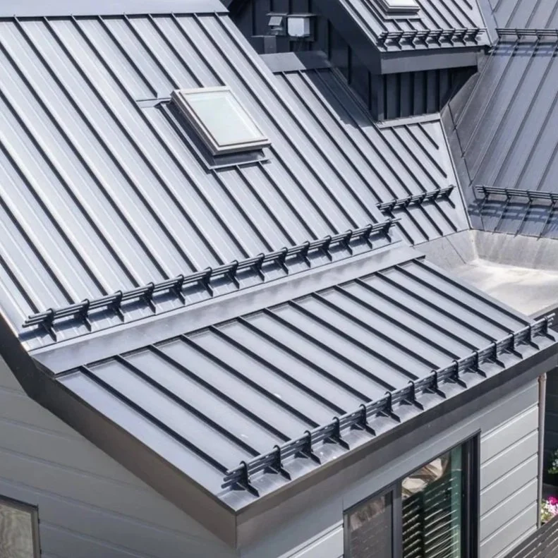Snow retention system installed on a standing seam metal roof, engineered for the heavy snowfall of the Sea to Sky Corridor.
