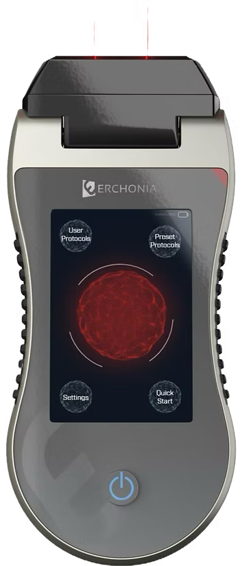 A portable medical device with a digital screen showing a red circular graphic, labeled with options like User Protocols, Preset Protocols, Settings, and Quick Start, and a power button at the bottom.