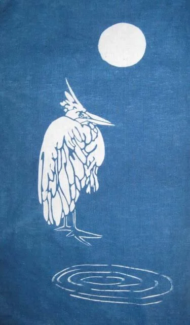 Silhouette of a heron with a crest on its head standing by a pond under a full moon in a minimalist, white line drawing style on a blue background.