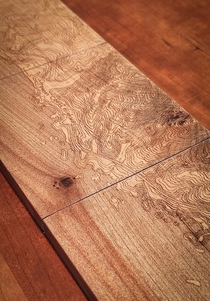 Close-up of a wooden surface showcasing a natural wood grain pattern and texture.