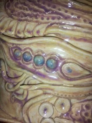 Close-up of a seashell showing intricate textures and vibrant purple and blue colors.