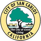 Seal of the City of San Carlos, California, featuring a large tree and two buildings with a blue sky background.