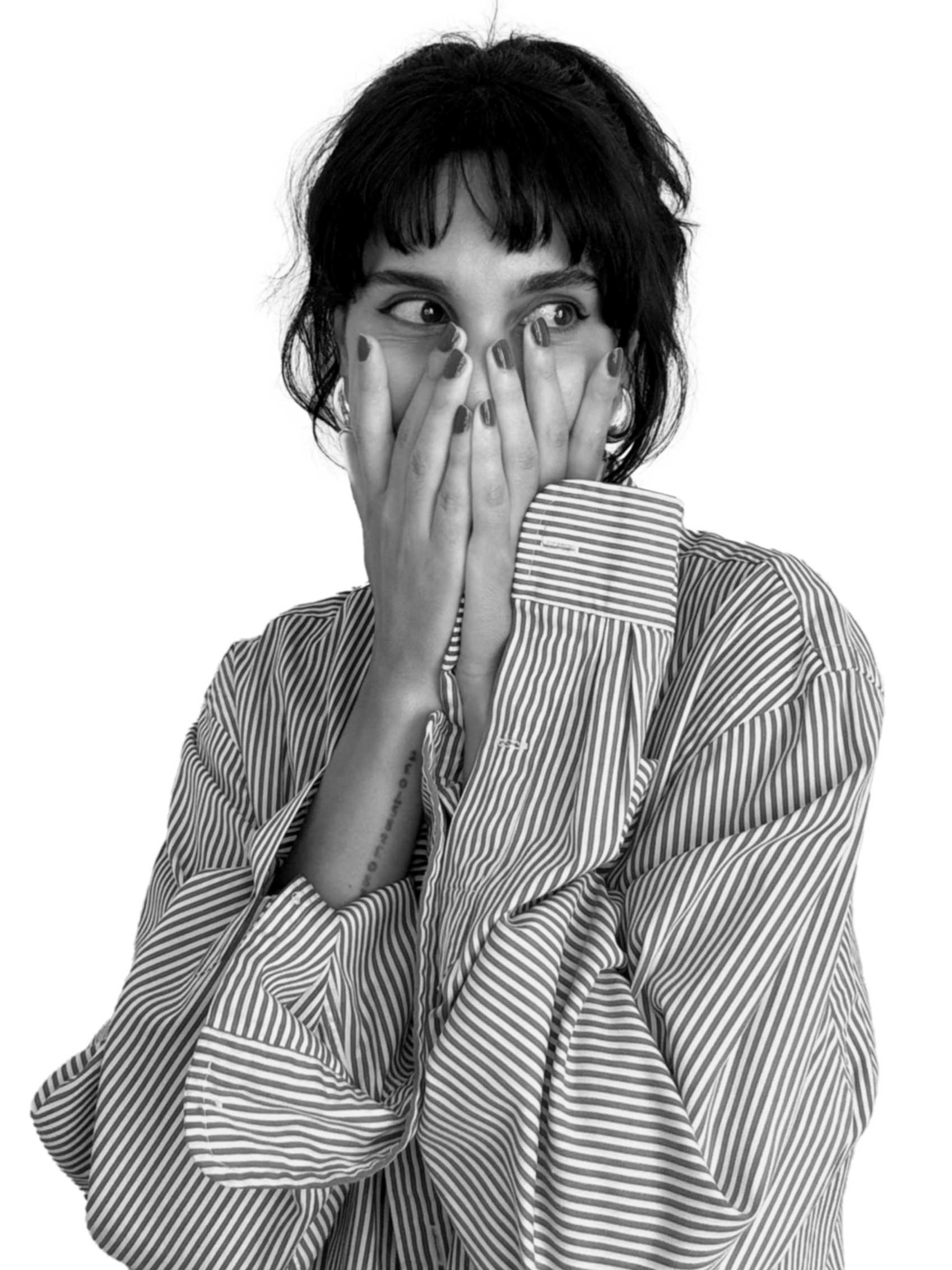 Black and white portrait of Daniela Vargas, fashion and footwear designer, wearing a striped long-sleeve shirt