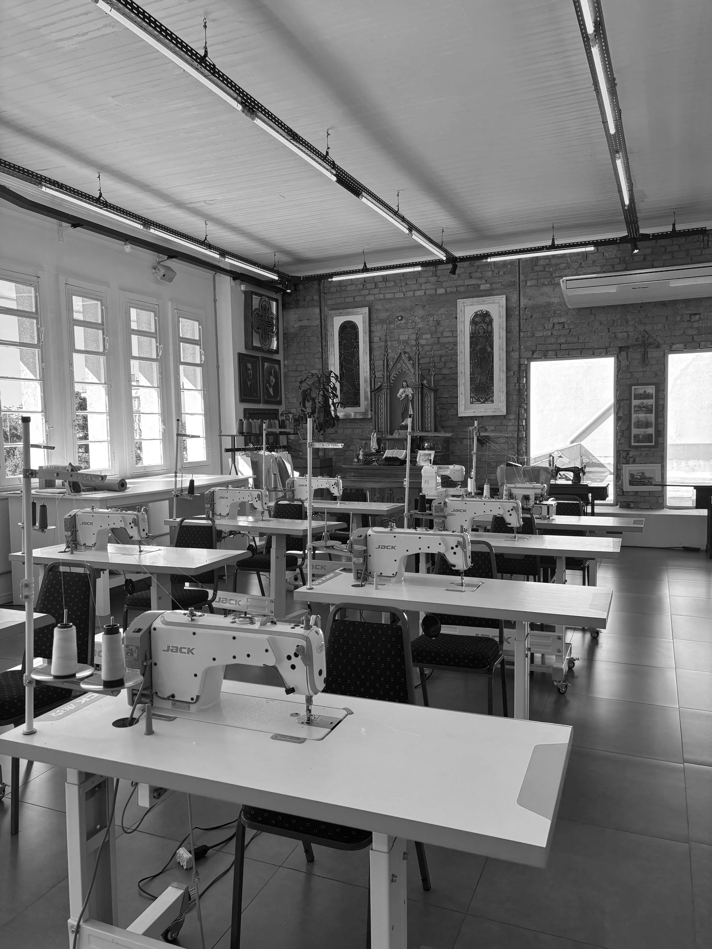 Light blue and white industrial sewing machines in a rustic fashion studio