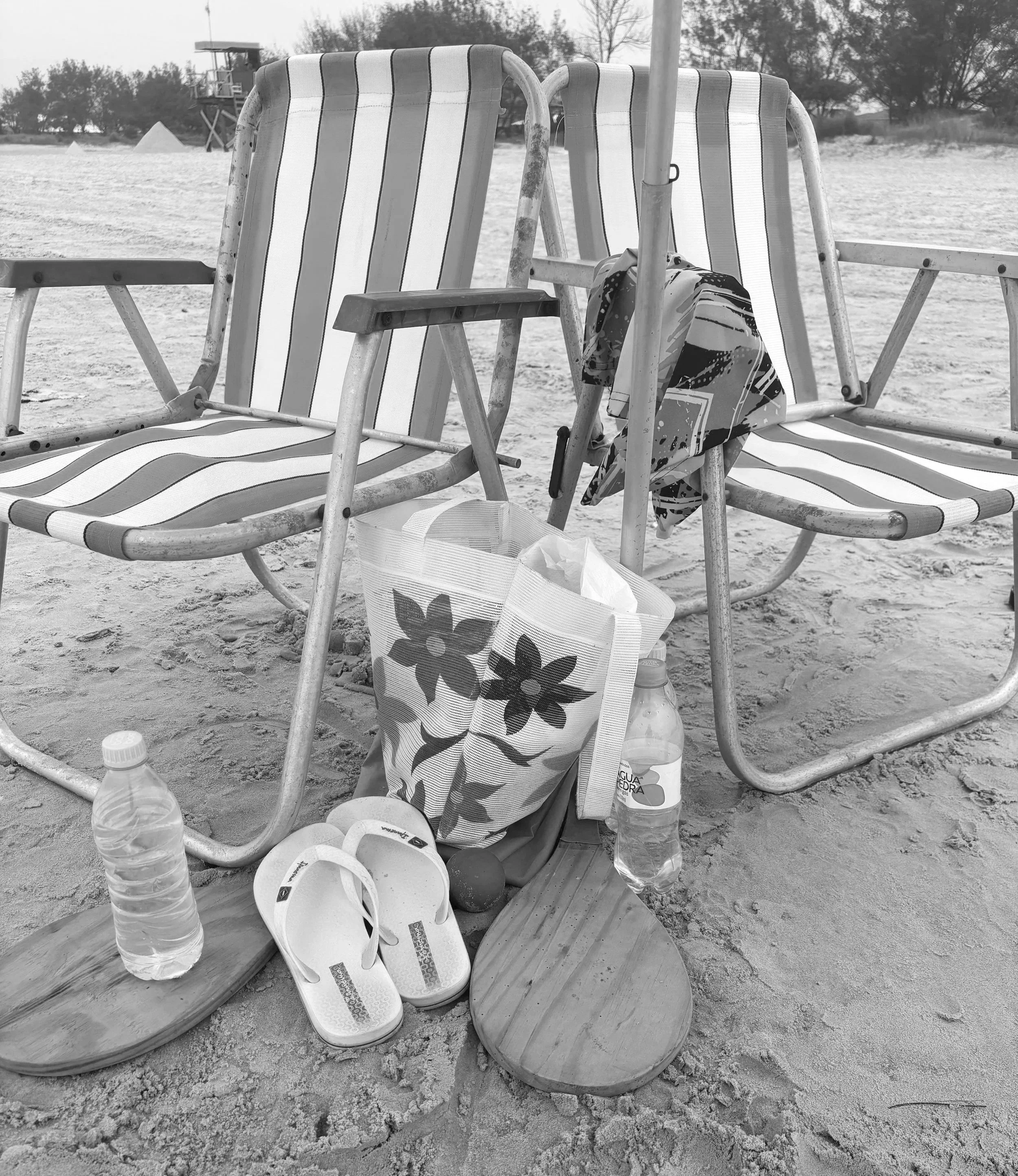 Beach lifestyle scene with striped chairs, bag, flip flops and tennis racket inspiring fashion product design