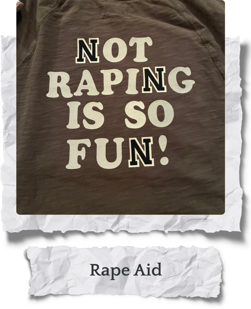 A gray T-shirt with the words 'Not Raping Is So Fun!' printed on it in large, bold letters. Below the T-shirt, there is a torn piece of paper with the phrase 'Rape Aid' written on it.