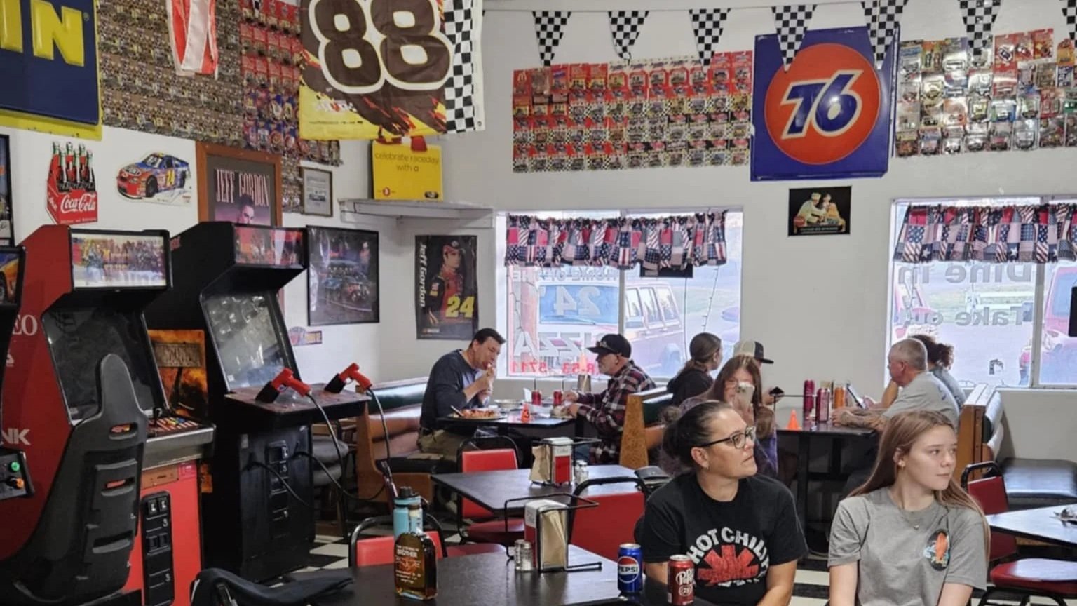 Patrons of Pit Stop Pizza's dining room and arcade in Heber-Overgaard, AZ
