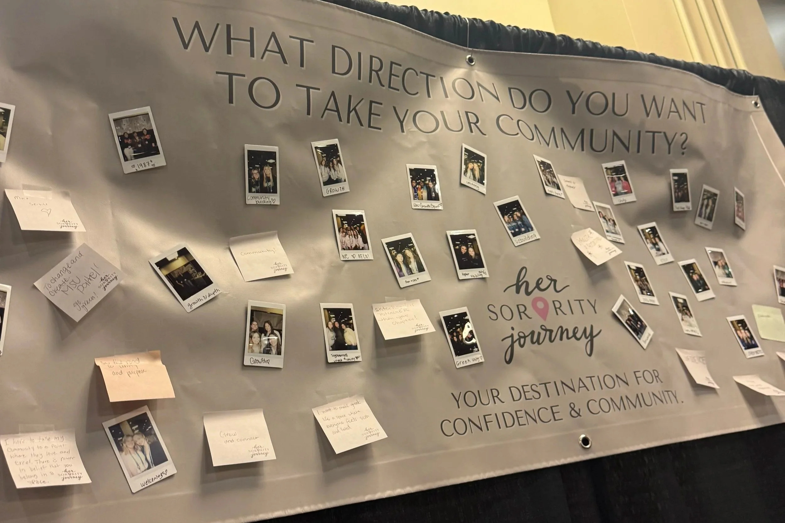 A display board with the question "What direction do you want to take your community?" written at the top. Below the question, there are numerous Polaroid photos and sticky notes with handwritten messages attached to the board. The messages seem to be about community building and personal journeys.