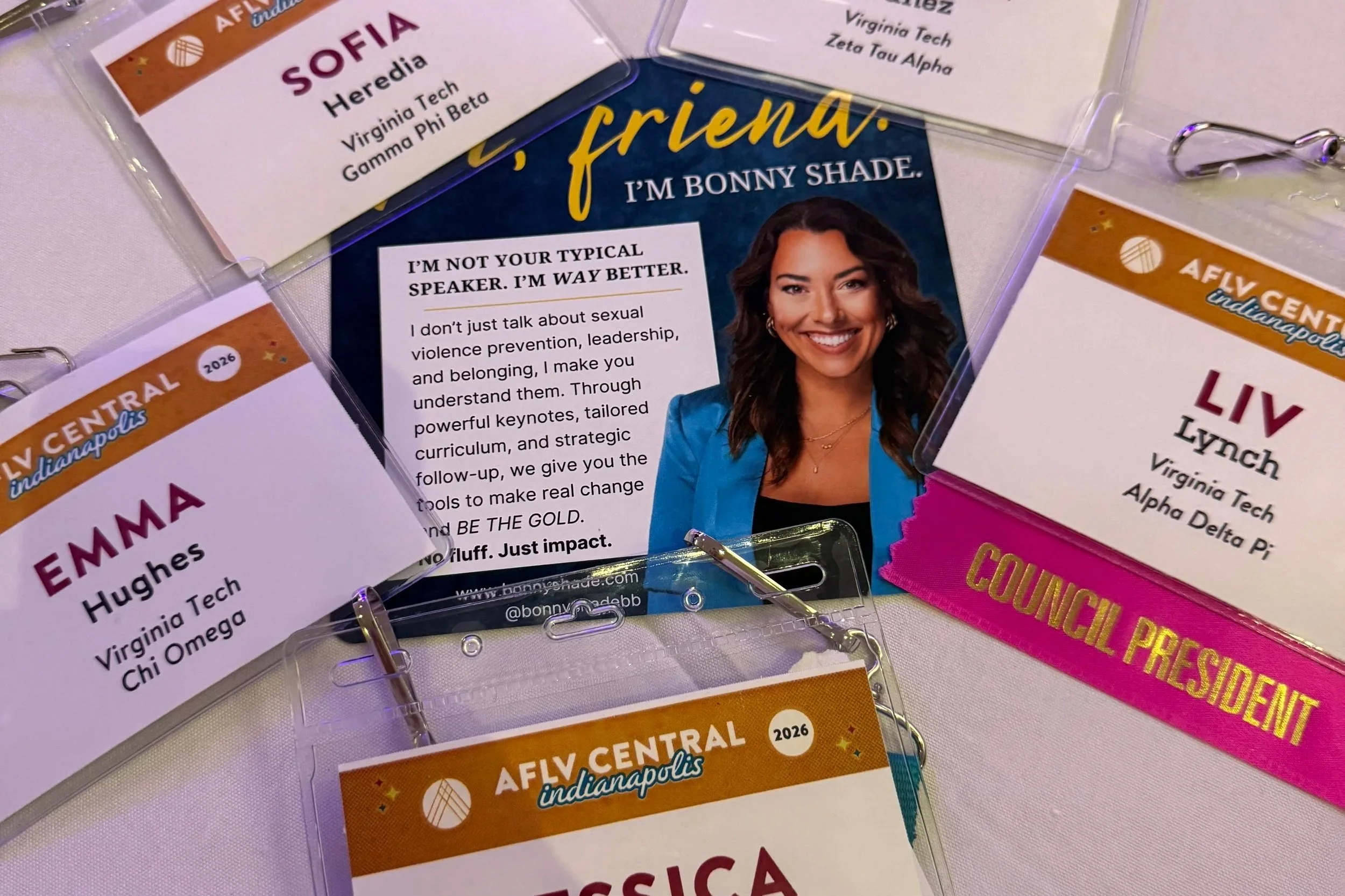 Conference nametags and promotional cards for an event at Fly Central Indianapolis, featuring speakers Heredia, Sofia; Emma Hughes; Virginia Tech, Zeta Tau Alpha, Delta Pi; and Lynch, Virginia Tech Alpha Delta Pi, with some tags including the year 2026 and titles like council president.