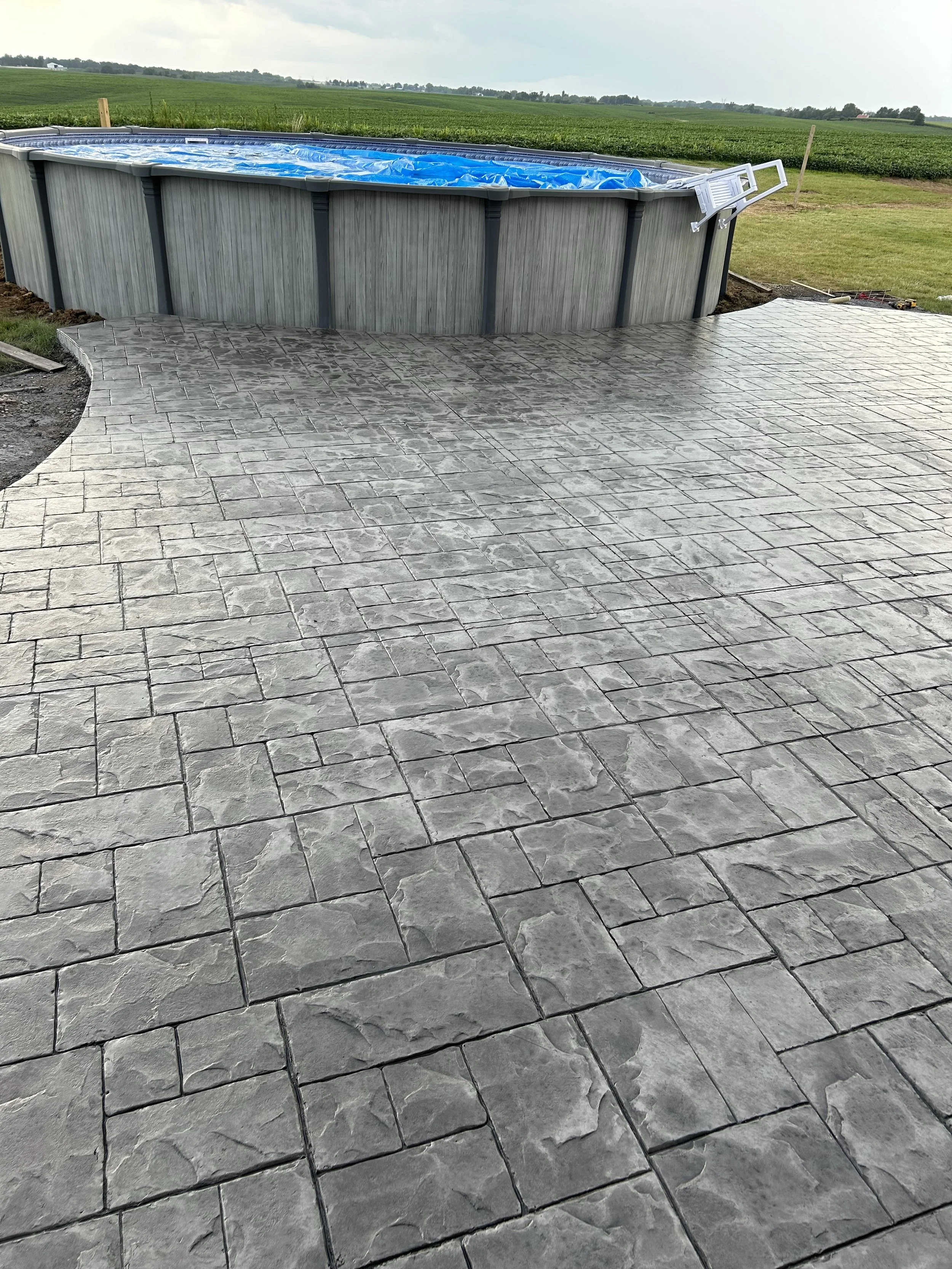 Pool patio, finished with two-tone stamped concrete 