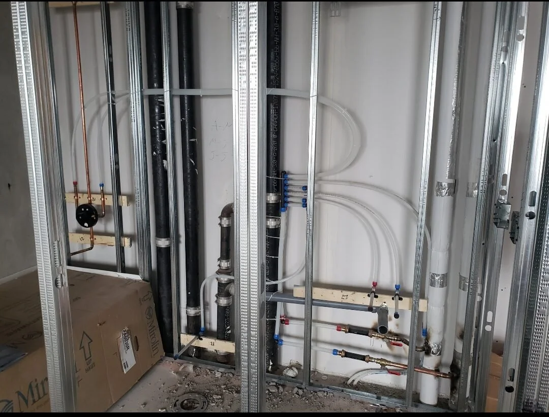 Open wall with plumbing and electrical pipes for a bathroom or kitchen installation