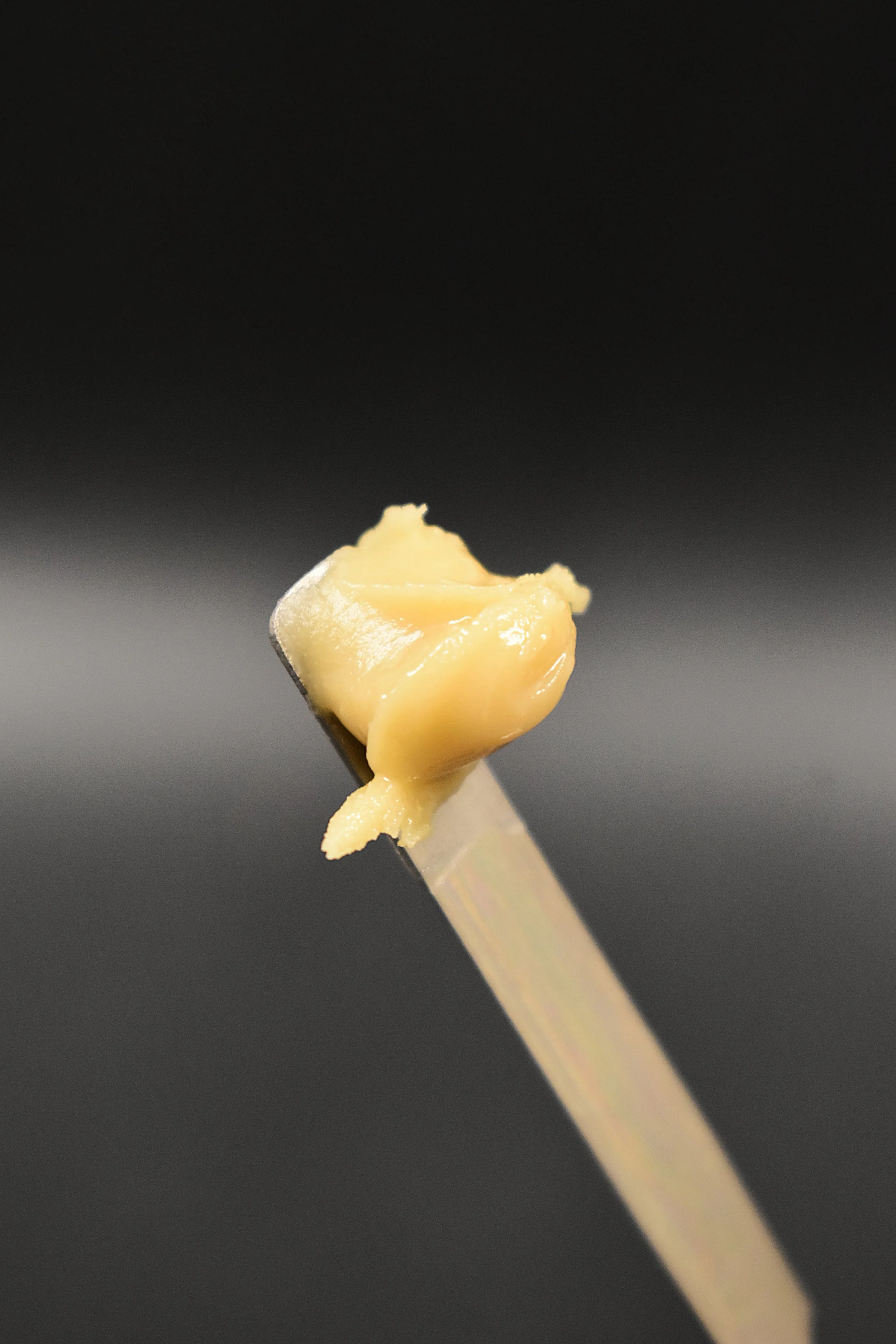 A close up of live rosin on a serving utensil